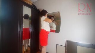 A naked lady does make-up in front of a mirror, puts on underwear, stockings, a skirt. 3